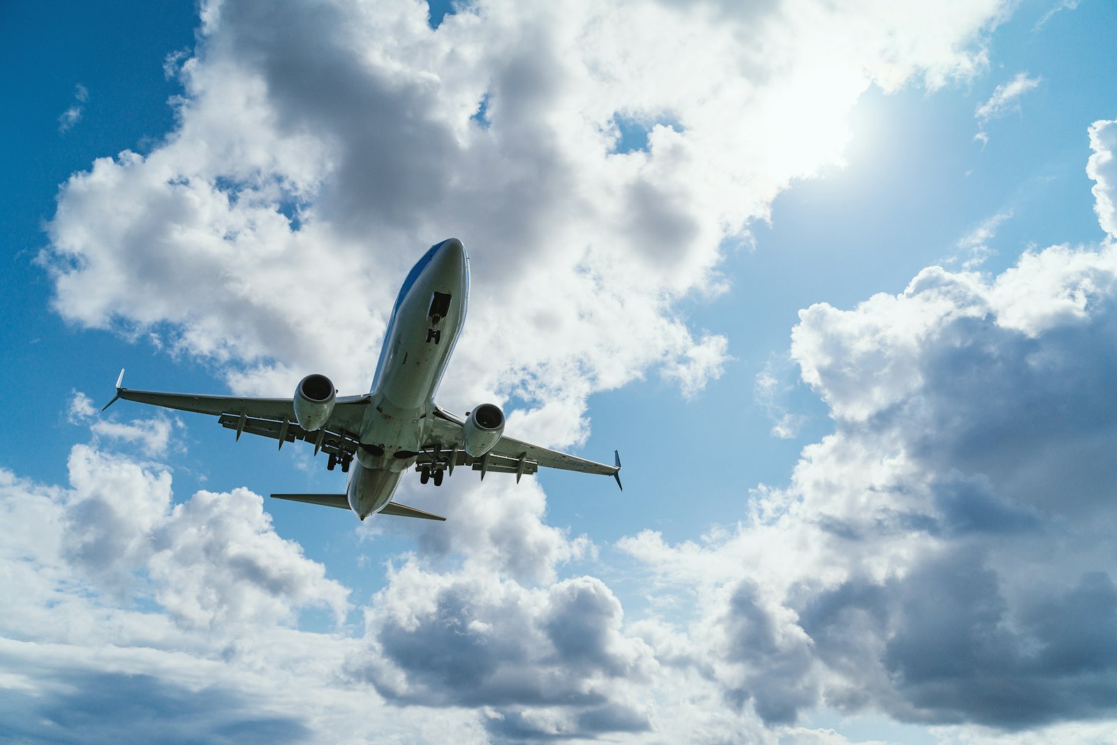 Aircraft climbing through scattered cloud