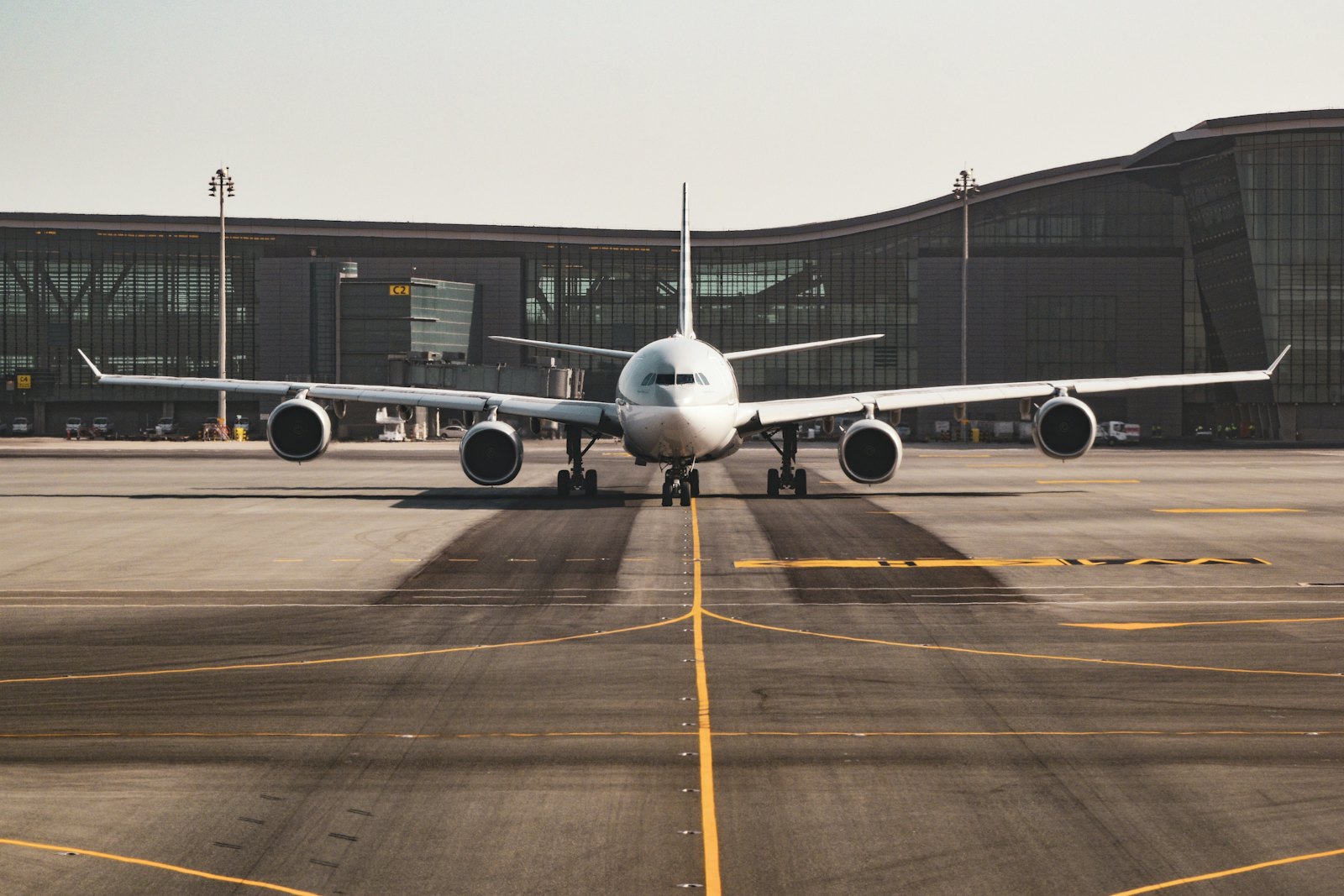 Wide-body aircraft facing down a marked runway